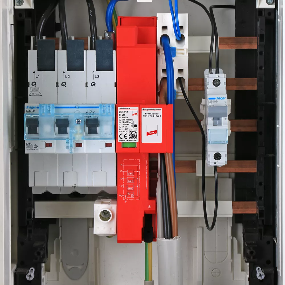 Close-up of an electrical distribution board showing circuit breakers, wiring, and a prominent DEHNshield ZP surge protection device.